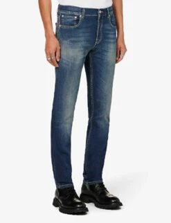 Alexander McQueen Graffiti Brand-embroidered Tapered-leg Regular-fit Stretch-denim Jeans -Selfridges Store R04153535 BLUEWASHED ALT02